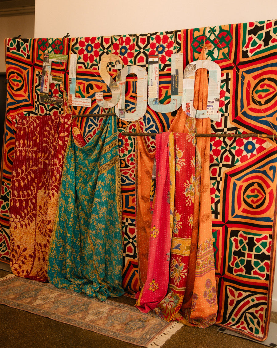 Colorful patterned textiles displayed at a cultural gathering photographed in the Dunes event collection